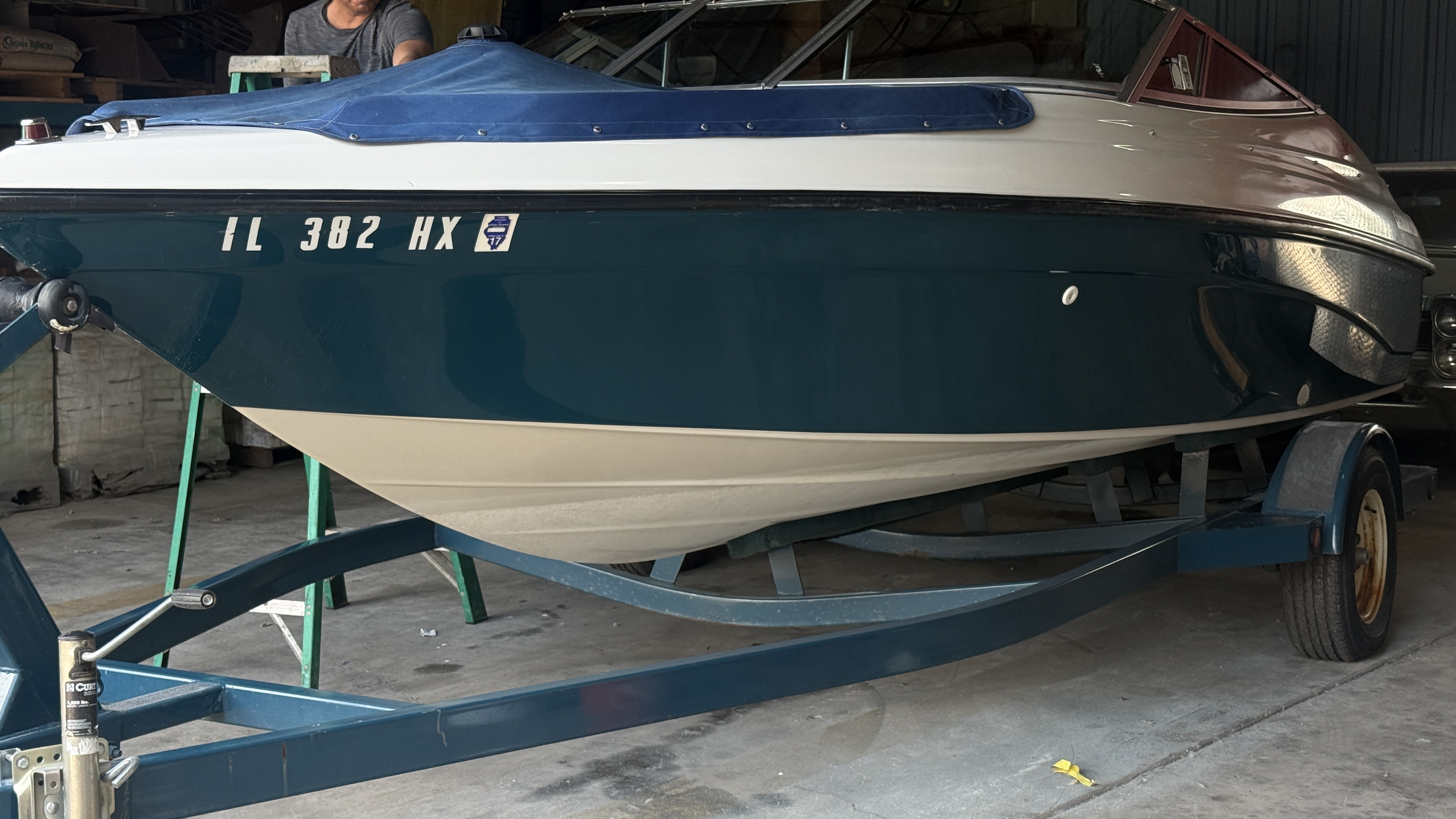 Boat after full detail — glossy restored teal hull