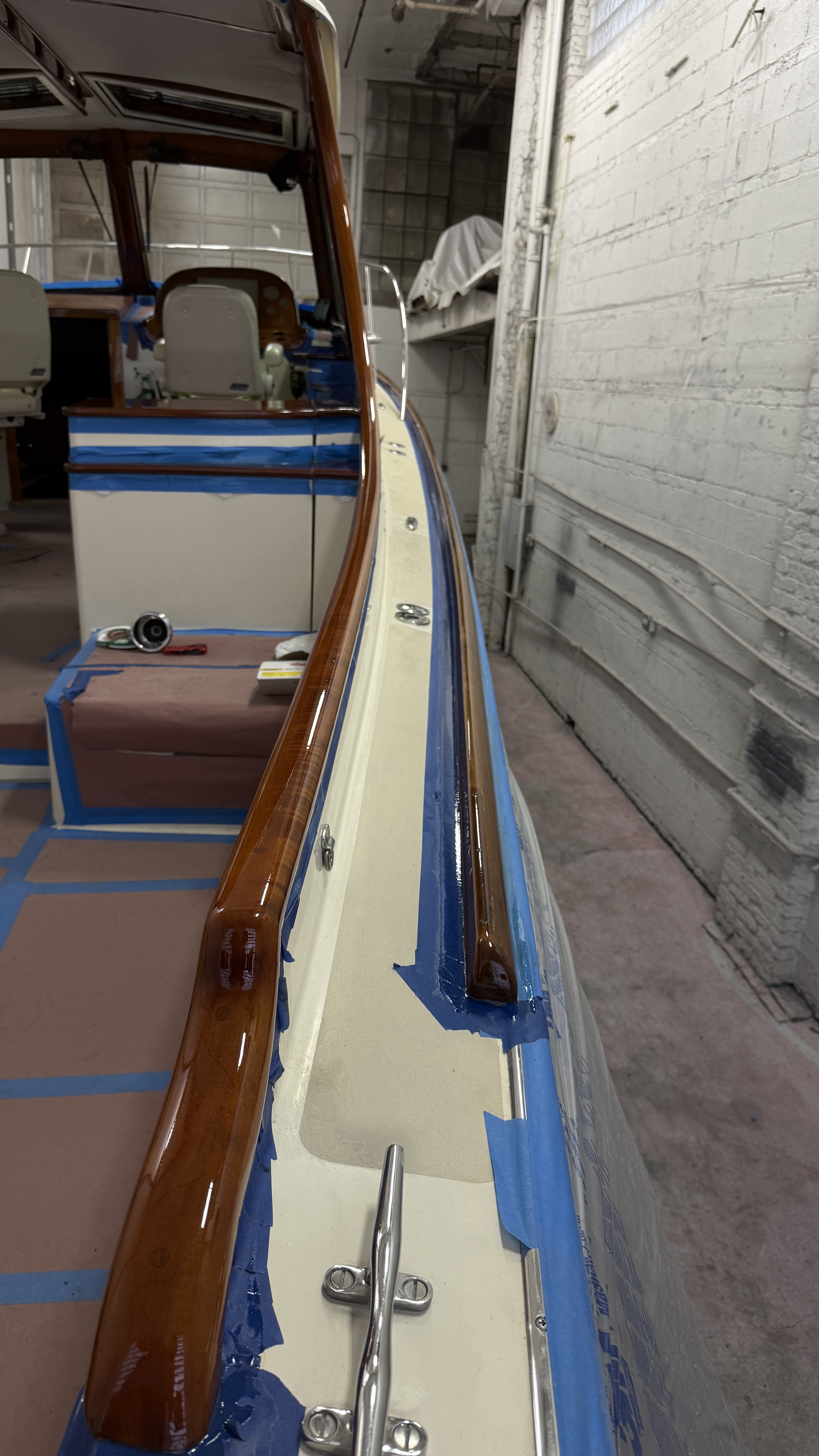 Hand-varnished cap rails along the hull